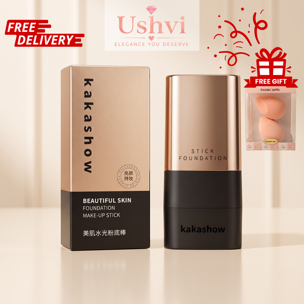 Kakashow Beautiful Skin Foundation Stick shown with its retail box on a clean light beige background. The foundation stick has a metallic rose-gold upper section and a black lower section, with the Kakashow brand name visible on both the box and the stick.