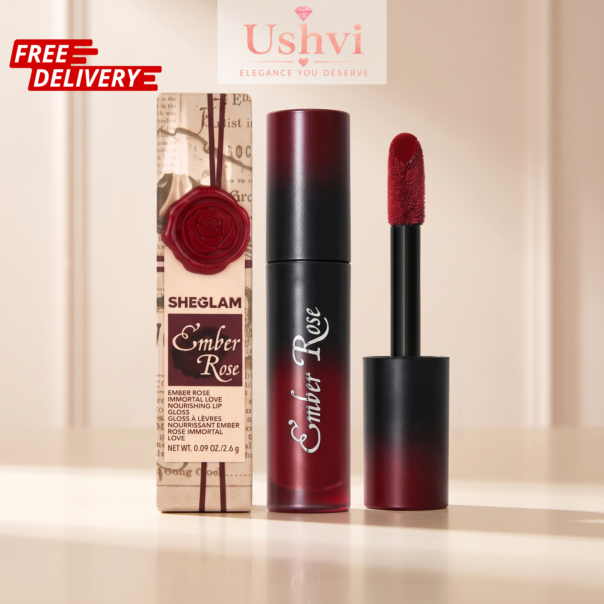 Sheglam Ember Rose nail polish shown with its retail box, the open bottle, and the applicator wand on a light beige background. The product features a deep berry-red color, and the packaging has a vintage paper design with a red wax seal.