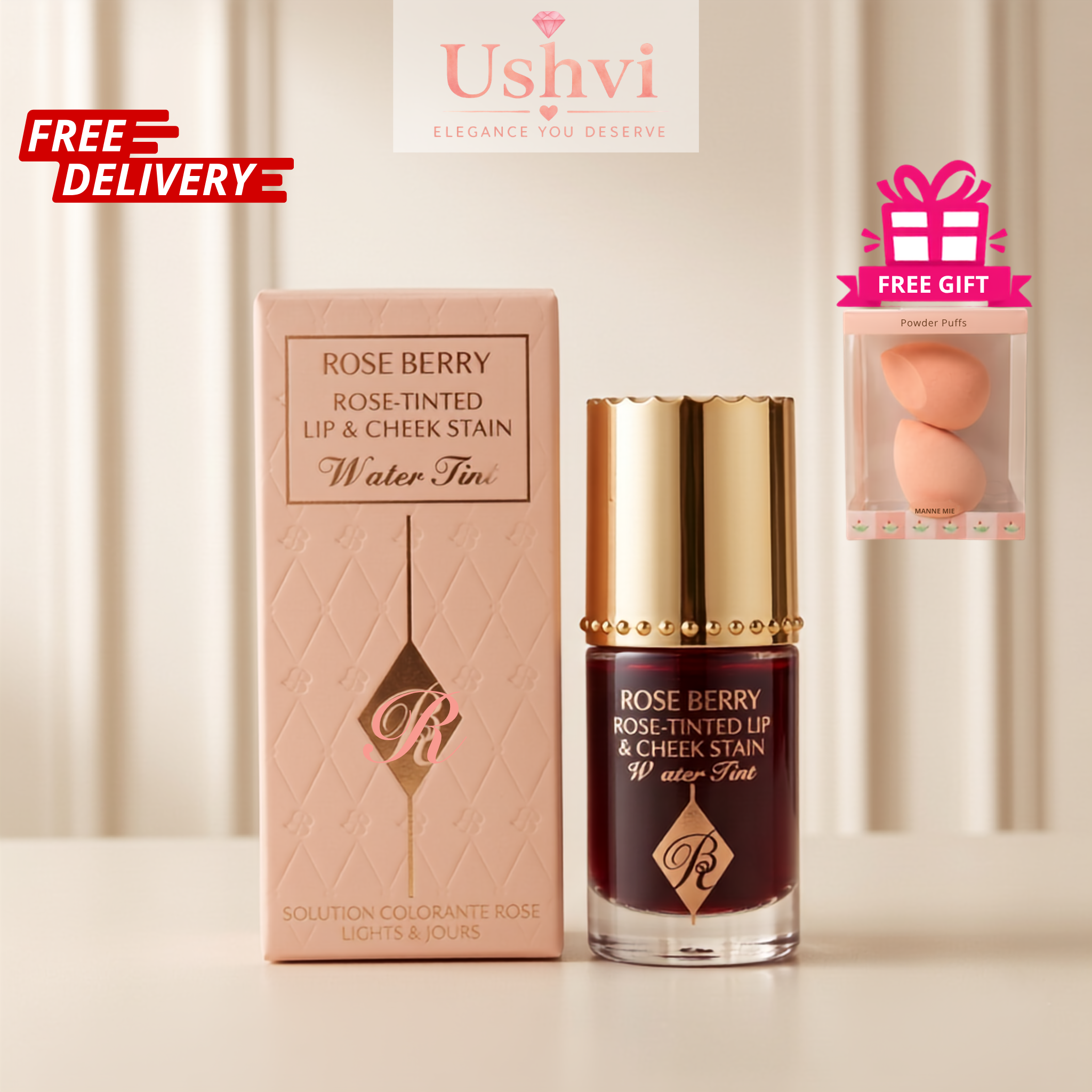 Ushvi Elegance For You Rose Berry Water Tint lip and cheek stain bottle with a gold cap next to its pink box, featuring a 'FREE GIFT' promo badge and a green Ushvi logo overlay.